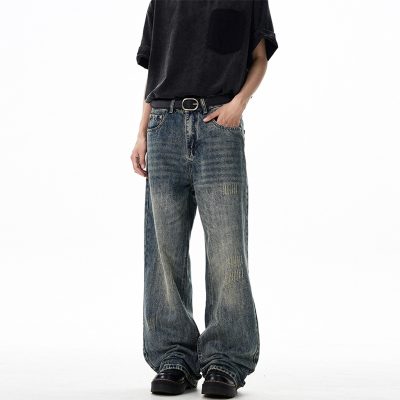 Model wearing loose fit distressed jeans in a casual setting