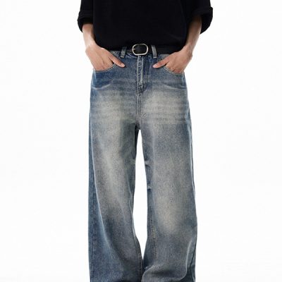 Close-up of distressed and washed details on wide-leg denim pants