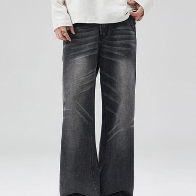 Close-up of elastic waist and cat whisker details on washed denim